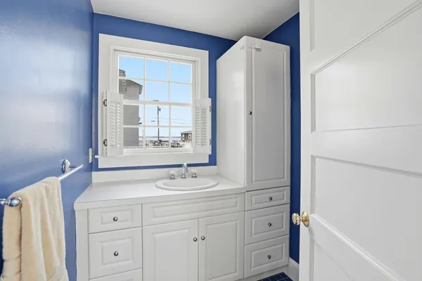 a bathroom with a sink vanity and a mirror