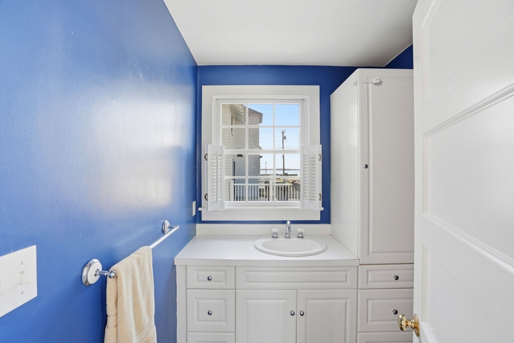 7 Mildred Street Hull, MA 02045 - Photo 27 of 42 a bathroom with a sink a vanity and a mirror