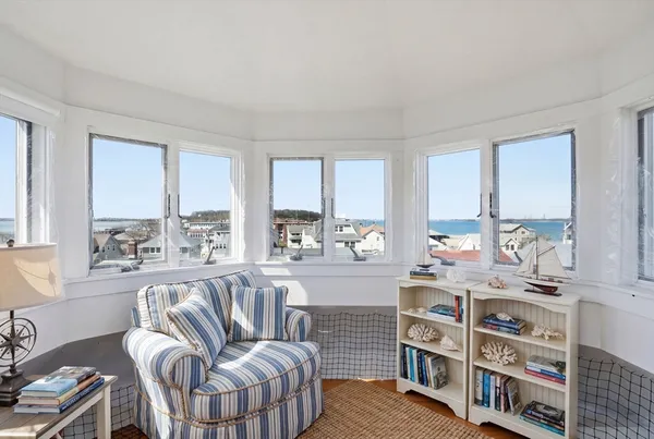 a living room with furniture a large window and a flat screen tv