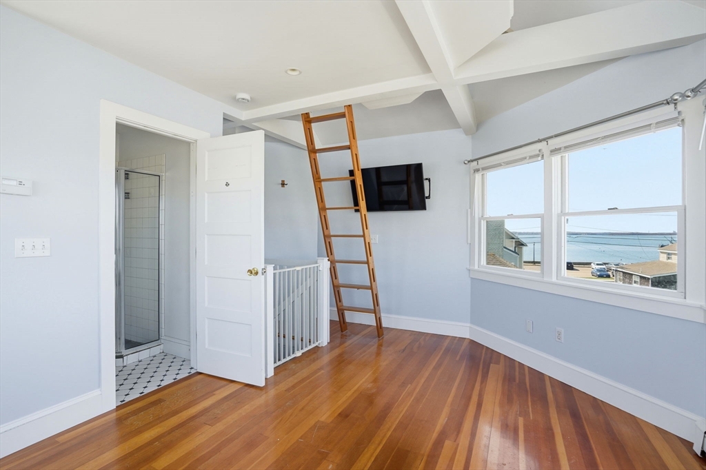 7 Mildred Street Hull, MA 02045 - Photo 7 of 42 a view of empty room with wooden floor and fan