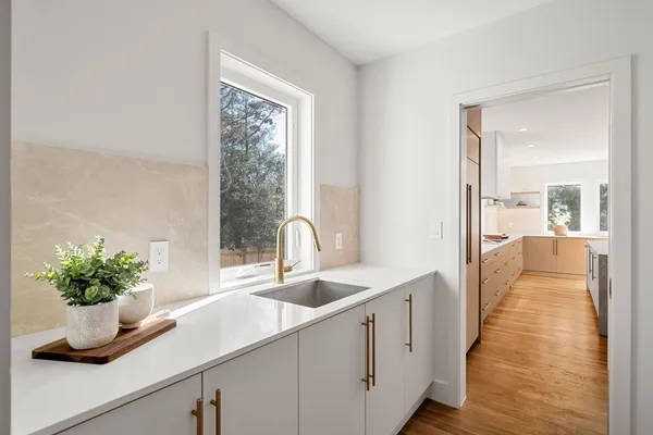 a hallway with sink and mirror