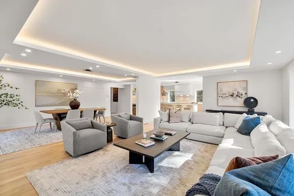 a living room with furniture and wooden floor