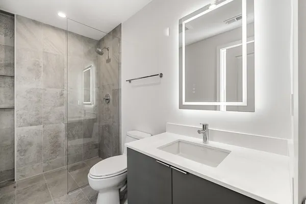a bathroom with a sink toilet and shower