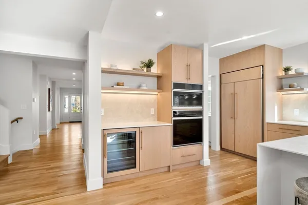 a kitchen with stainless steel appliances a refrigerator and a stove top oven