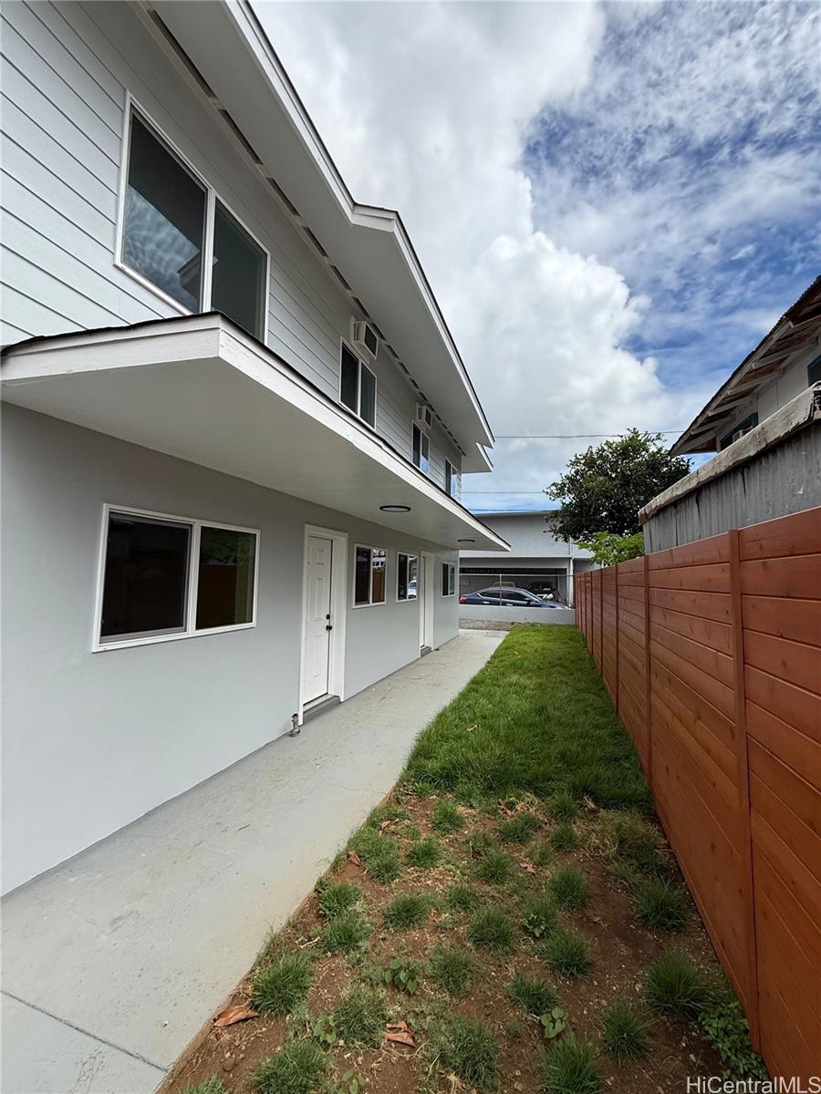 2711 Waiaka Road Honolulu, HI 96826 - Photo 11 of 19 a yellow and red house with a yard
