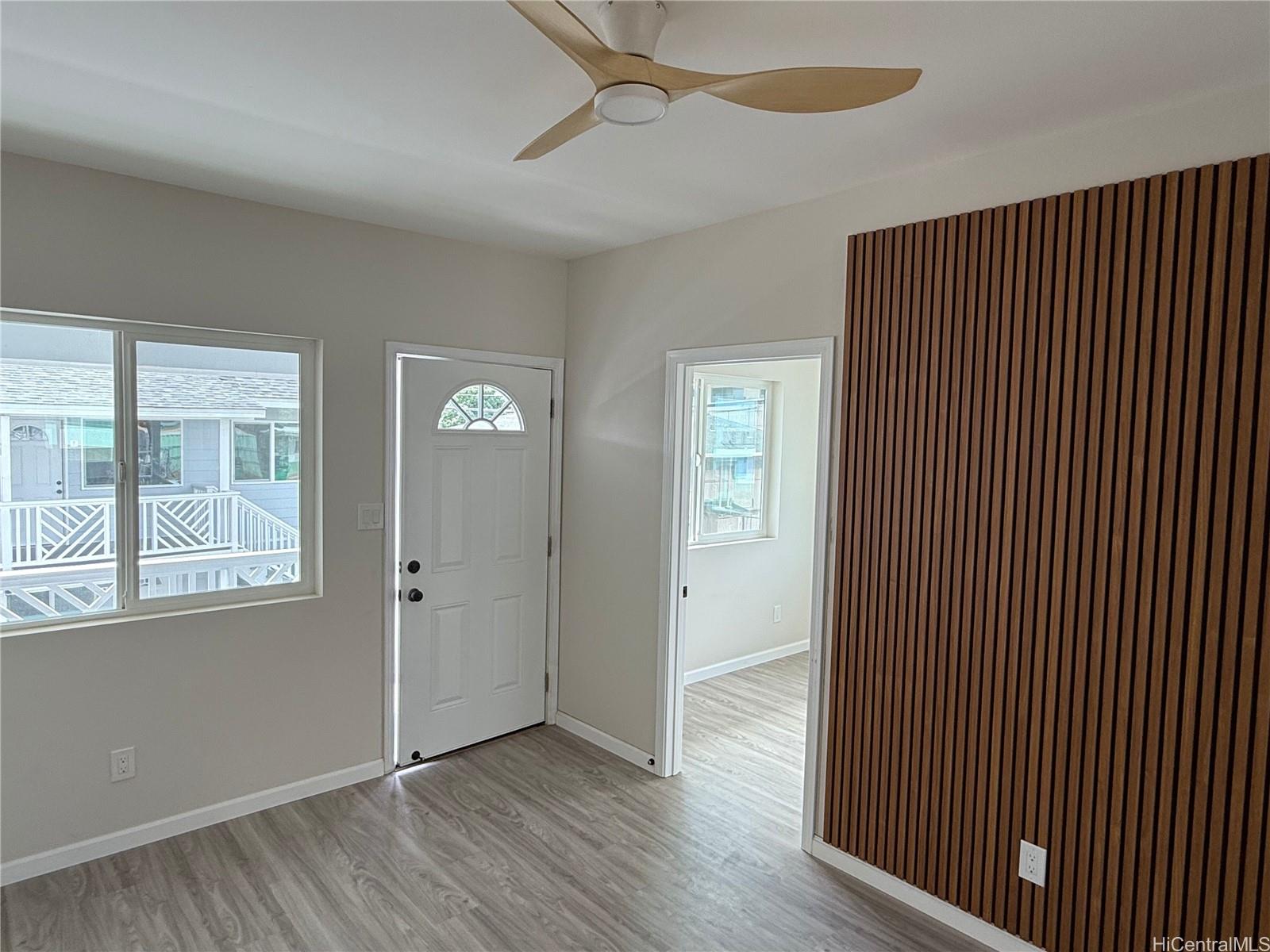 2711 Waiaka Road Honolulu, HI 96826 - Photo 19 of 19 a view of an empty room with wooden floor and a window