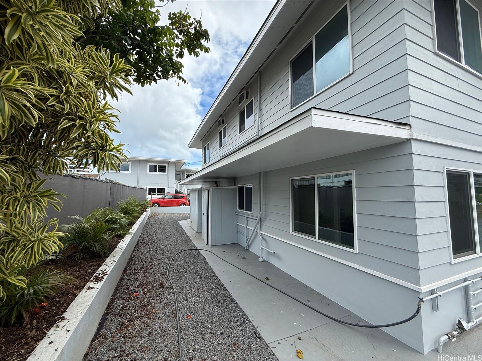 2711 Waiaka Road Honolulu, HI 96826 - Photo 9 of 19 a view of a house with a yard and potted plants