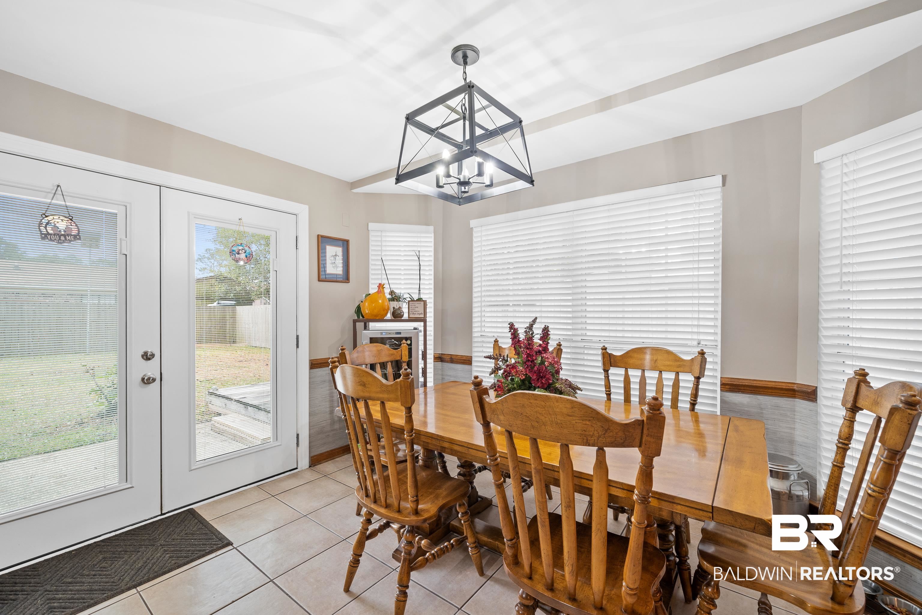 460 Ridgewood Drive Daphne, AL 36526 - Photo 7 of 31 Dining space with plenty of natural light, light tile patterned floors, french doors, and a notable chandelier