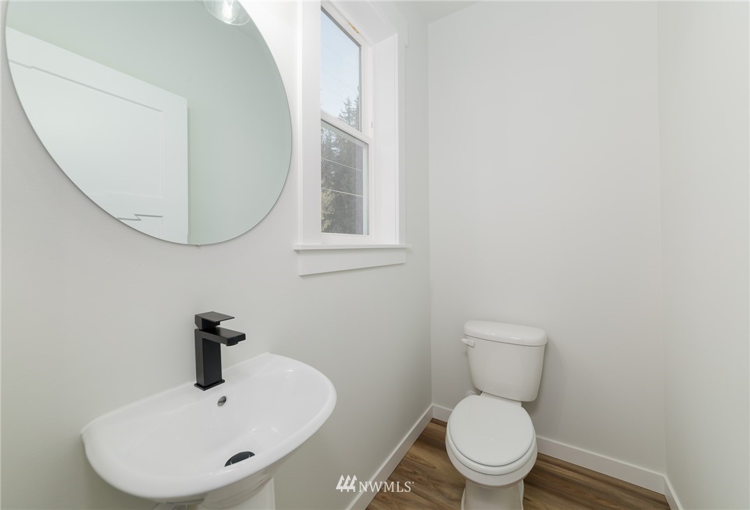 2716 Callow Road, Unit A Lake Stevens, WA 98258 - Photo 20 of 34 a white toilet sitting next to a bathroom sink