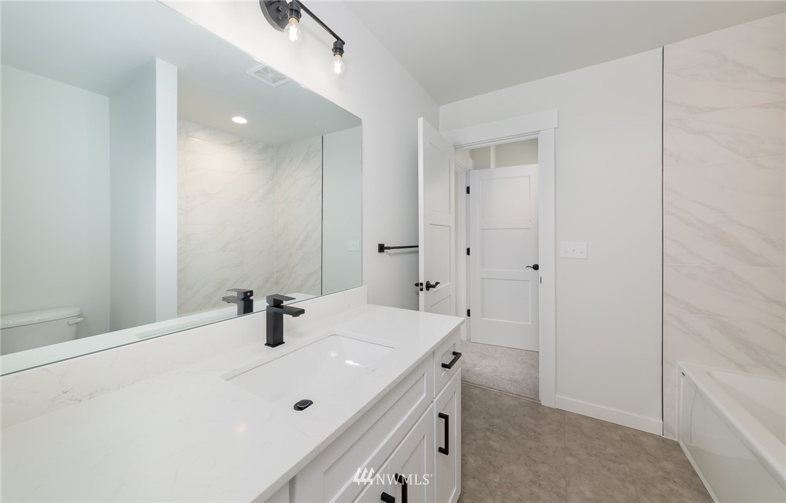 2716 Callow Road, Unit A Lake Stevens, WA 98258 - Photo 24 of 34 a bathroom with a sink a mirror and shower