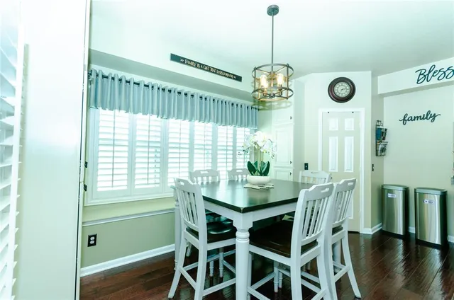 a dining room with furniture a chandelier and window