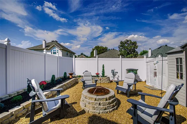 a roof deck with table and chairs