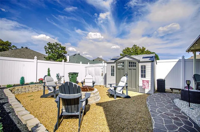 an aerial view of residential houses with outdoor space and trees all around