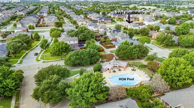 an aerial view of a house with yard swimming pool and outdoor seating