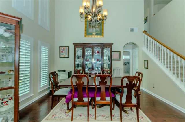 a view of a dining room with furniture and chandelier