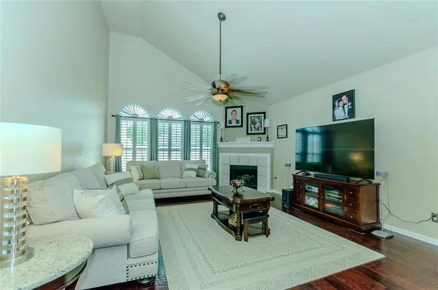 a living room with furniture a flat screen tv and a fireplace