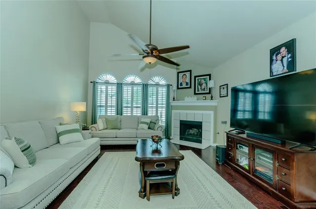 a living room with furniture a fireplace and a flat screen tv