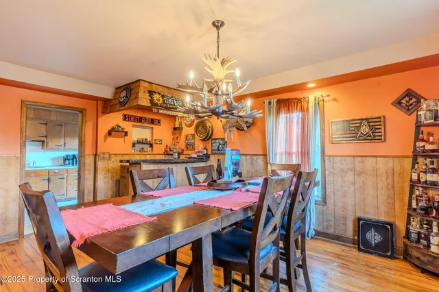 a view of a dining room with furniture and wooden floor