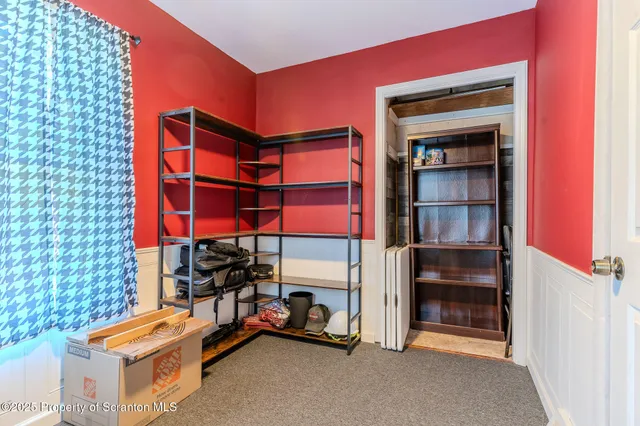 a view of room with window and wooden floor
