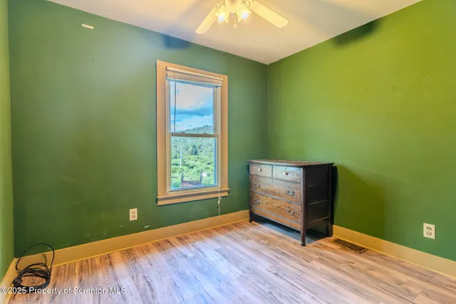 a view of a hallway with a livingroom and furniture