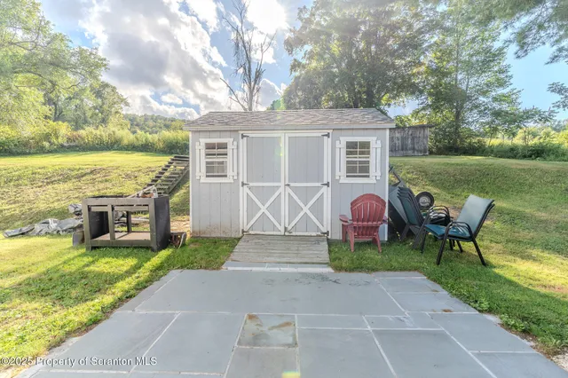 a view of a house with backyard porch and garden