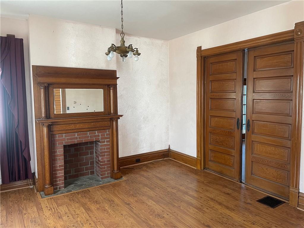 943 Newell Road Fayette City, PA 15438 - Photo 6 of 27 a view of an empty room with a fireplace and a window