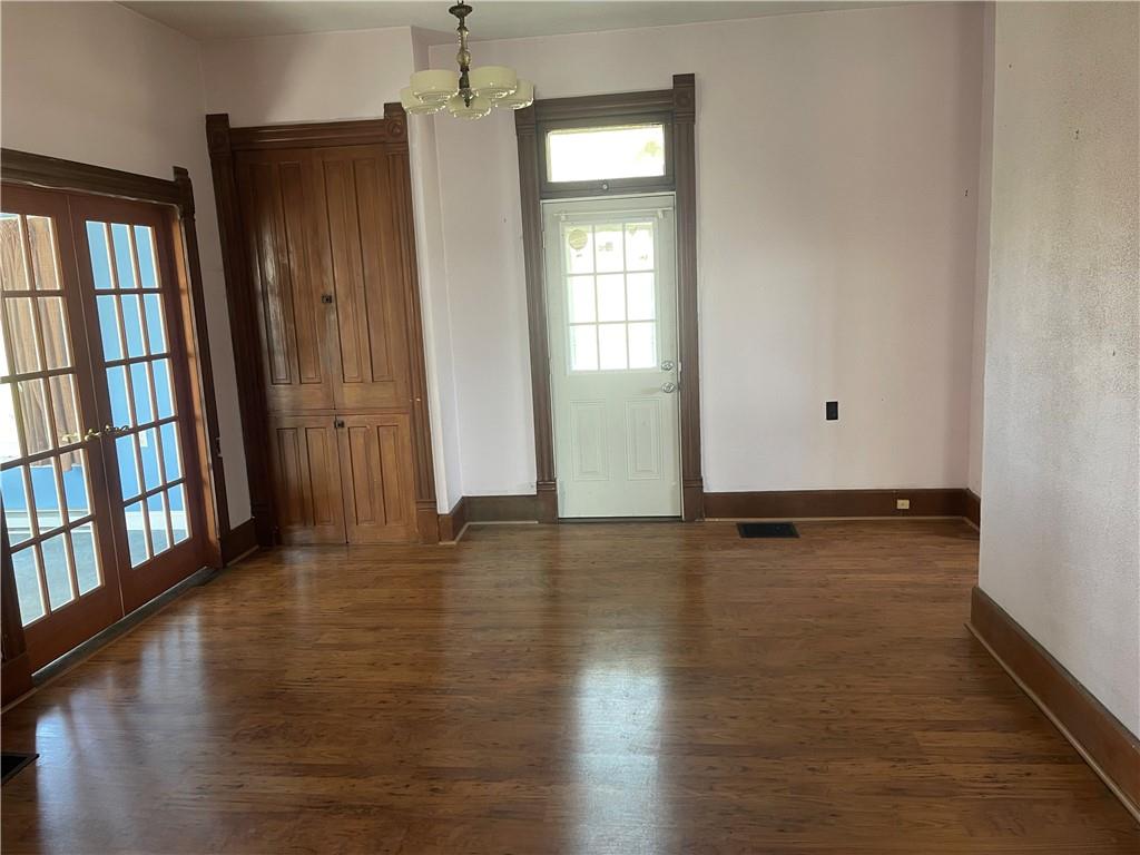 943 Newell Road Fayette City, PA 15438 - Photo 7 of 27 a view of an empty room with window and hardwood floor