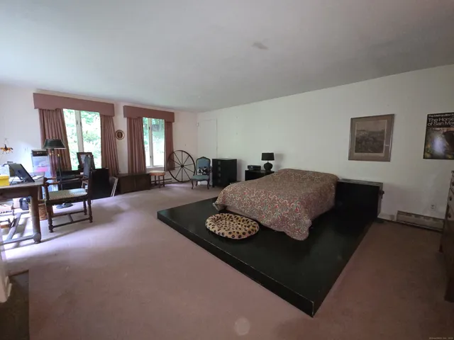 a living room with furniture and a dining table