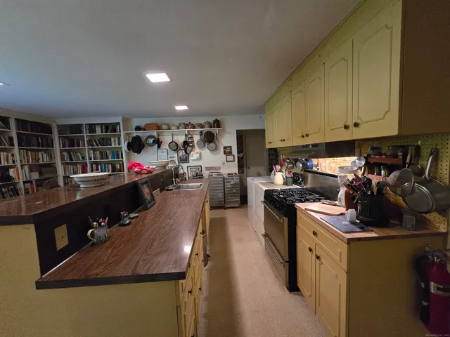 a kitchen with stainless steel appliances granite countertop a sink stove and cabinets