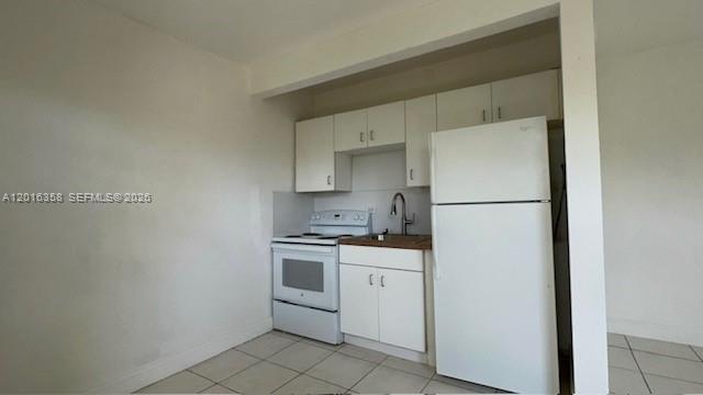 441 Southwest 10th Street, Unit 4 Miami, FL 33130 - Photo 12 of 18 a kitchen with a sink a refrigerator and cabinets