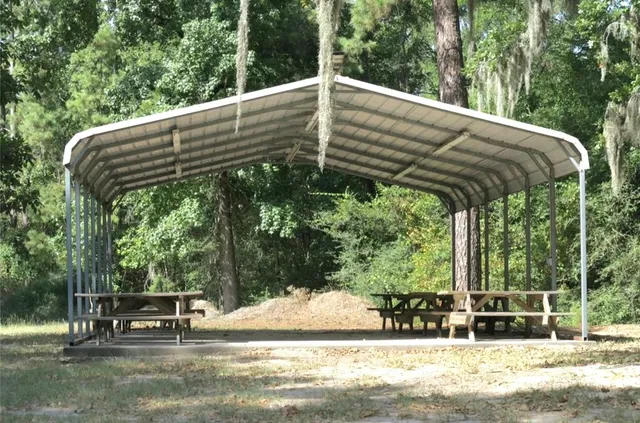 a view of a patio with table and chairs under an umbrella