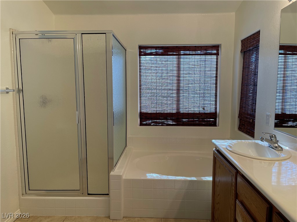 9975 Willowbrook Pond Road Las Vegas, NV 89148 - Photo 13 of 18 Full bath with a stall shower, vanity, and a bath