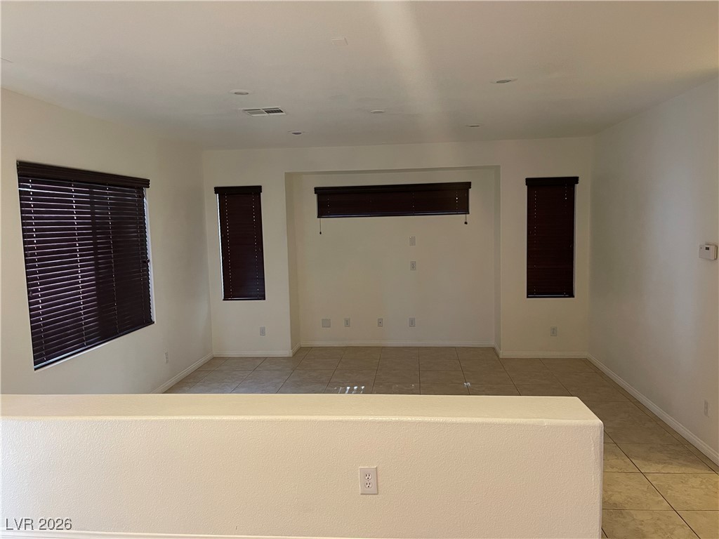 9975 Willowbrook Pond Road Las Vegas, NV 89148 - Photo 3 of 18 Empty room with light tile patterned flooring and baseboards