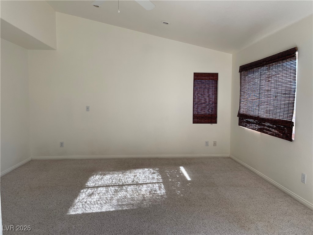 9975 Willowbrook Pond Road Las Vegas, NV 89148 - Photo 10 of 18 Unfurnished room featuring lofted ceiling, carpet, and ceiling fan