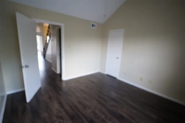 a view of hallway with furniture and wooden floor