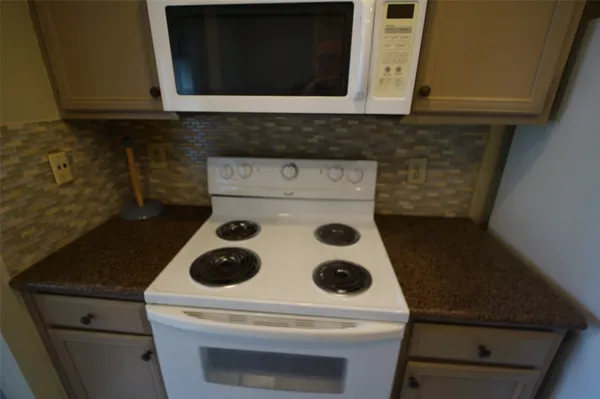 a view of backyard with trampoline
