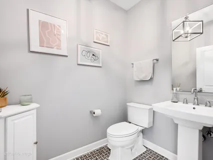 a bathroom with a sink mirror and toilet