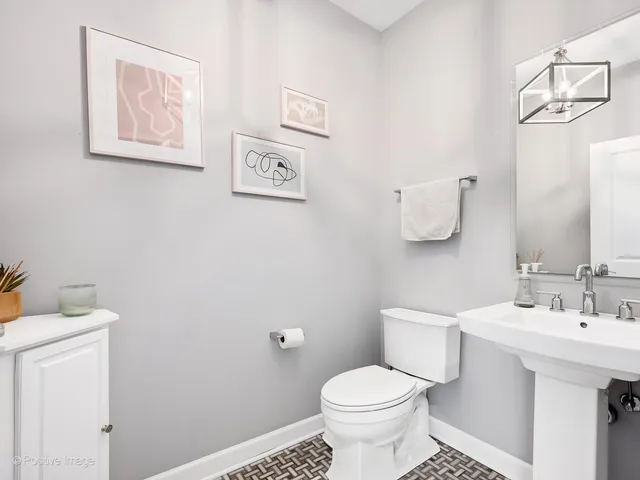 a bathroom with a sink mirror and toilet
