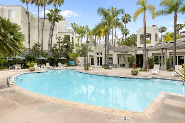 a view of swimming pool with outdoor seating and plants