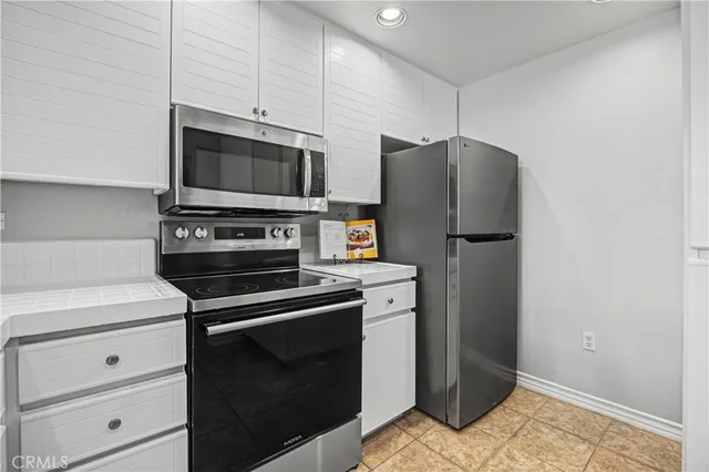 a kitchen with a refrigerator stove and microwave