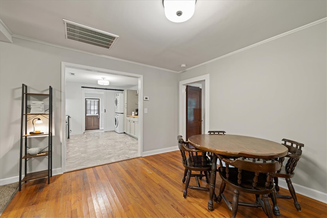 174 Holliday Road Six Mile, SC 29682 - Photo 11 of 49 Hardwood floors flow through this welcoming dining area, leading to the expansive open kitchen