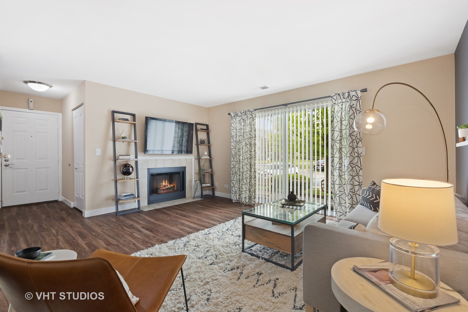 77 Kensington Circle, Unit 301 Wheaton, IL 60189 - Photo 4 of 40 a living room with furniture and a fireplace