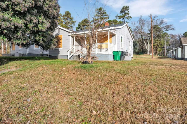 a view of a house with a yard and garage