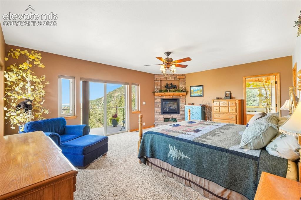 858 Oak Ridge Road Manitou Springs, CO 80829 - Photo 24 of 50 Primary bedroom on lower level with a private walk out deck, a gas fireplace, a walk in closet and an en suite 5 piece bathroom