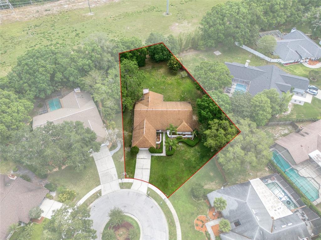 an aerial view of a house with yard swimming pool and outdoor seating