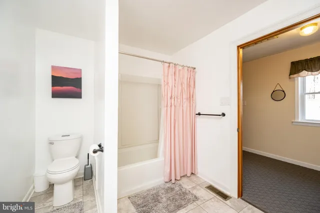 a view of a porch with wooden floor and furniture