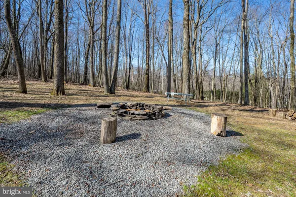 a kitchen with stainless steel appliances granite countertop a refrigerator a stove a sink dishwasher and white cabinets with wooden floor