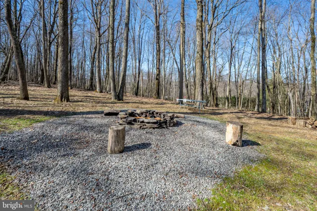 a kitchen with stainless steel appliances granite countertop a refrigerator a stove a sink dishwasher and white cabinets with wooden floor