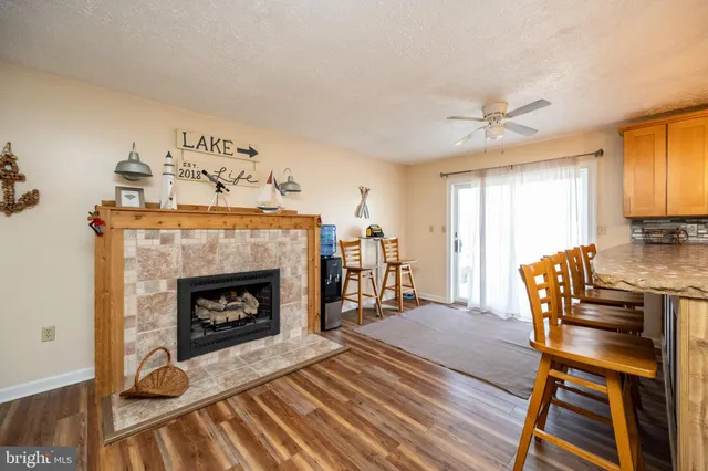 a kitchen with stainless steel appliances granite countertop a sink a stove and a wooden floors