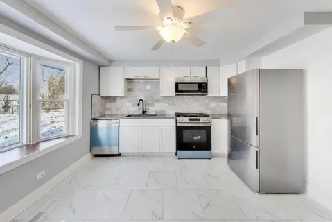 a kitchen with stainless steel appliances a refrigerator sink and stove